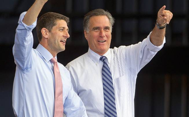 Republican presidential candidate Mitt Romney, right, takes the stage with vice presidential candidate Paul Ryan during a campaign rally at the Henderson Pavilion Tuesday, Oct. 23, 2012.