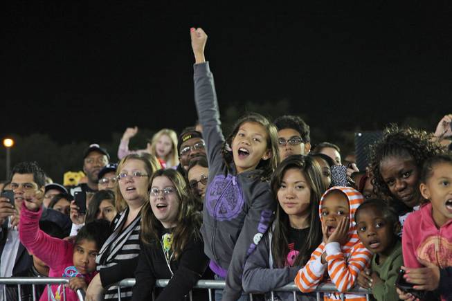Carly Neves, 10, fist-pumps the air as she sings along to Katy Perry's performance at President Barack Obama's rally at Doolittle Park Wednesday night, Oct. 24, 2012.