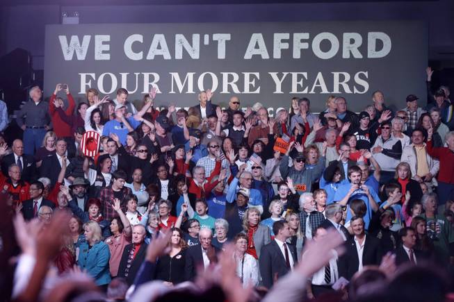 Audience members raise their hands in the air during a musical performance of "Glory, Glory" before Republican presidential candidate, former Massachusetts Gov. Mitt Romney arrives to speak at an election campaign rally at the Reno Event Center in Reno, Nev., Wednesday, Oct. 24, 2012. 
