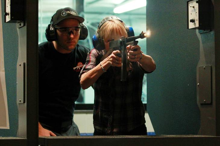 Lisa Gatewood fires a Thompson submachine gun at the Guns and Ammo Garage Oct. 25, 2012.