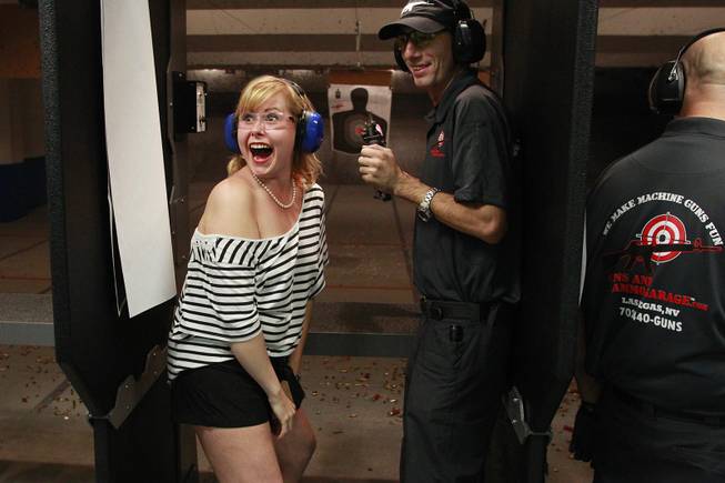 Roxie Jekosz reacts after firing a machine gun at the Guns and Ammo Garage Oct. 25, 2012.