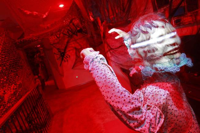 An animatronic child with a spinning head is seen in Vonny and Grant Traub's  house that has been decorated for Halloween Friday, Oct. 26, 2012.