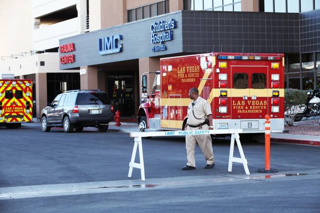 A hospital security officer patrols outside the Trauma Center at University Medical Center Friday, Oct. 26, 2012; the admittance area outside the Trauma Center was barricaded while Sen. Harry Reid was being treated at the hospital.