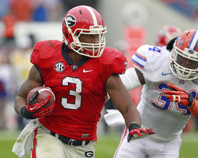Georgia running back Todd Gurley gets around Florida linebacker Lerentee McCray for yardage during the first half Saturday, Oct. 27, 2012, in Jacksonville, Fla.