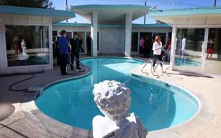 Patrons tour a home that is for sale on Spencer Street in the Paradise Palms neighborhood during a midcentury modern bus tour of homes in Las Vegas on Sunday, October 28, 2012.