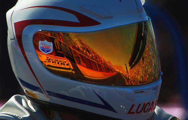 The Strip at Las Vegas Motor Speedway is reflected in the visor of pro stock motorcycle racer Hector Arana during the 12th Annual Big O Tires Nationals NHRA drag Sunday, Oct. 28, 2012.
