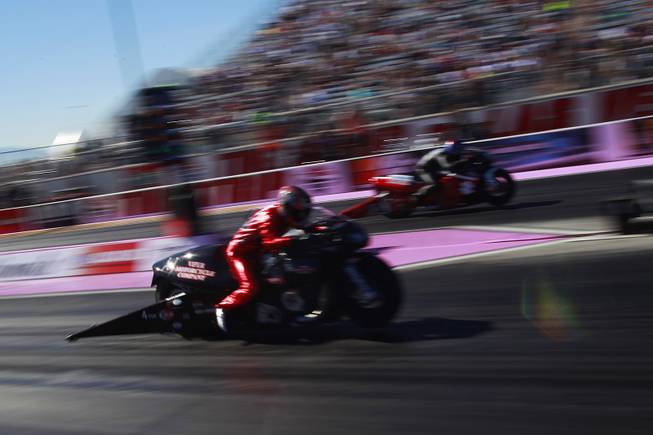 Pro stock motorcycle racers Matt Smith, left, and Scotty Pollacheck leave the starting line during the 12th Annual Big O Tires Nationals NHRA drag race on The Strip at Las Vegas Motor Speedway Sunday, Oct. 28, 2012.