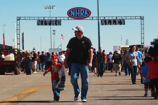 Race fans walk down Nitro Alley during the 12th Annual Big O Tires Nationals NHRA drag race on The Strip at Las Vegas Motor SpeedwaySunday, Oct. 28, 2012.