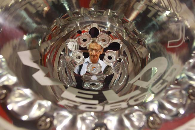 Attendee Tony Tobias is seen through a drag racing wheel at the SEMA conventionTuesday, Oct. 30, 2012.