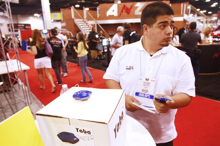 Tyler James shows off one of his company's Yaba speakers at the SEMA conventionTuesday, Oct. 30, 2012.
