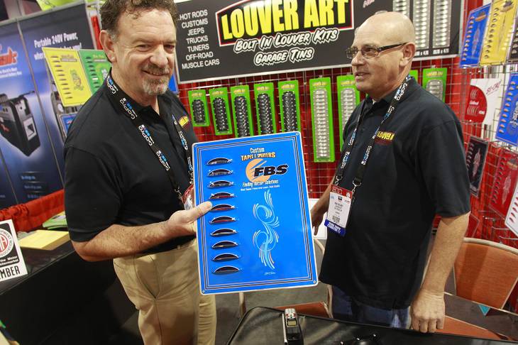 Paul Degagne from Louver Art displays one of the company's products at the SEMA conventionTuesday, Oct. 30, 2012.