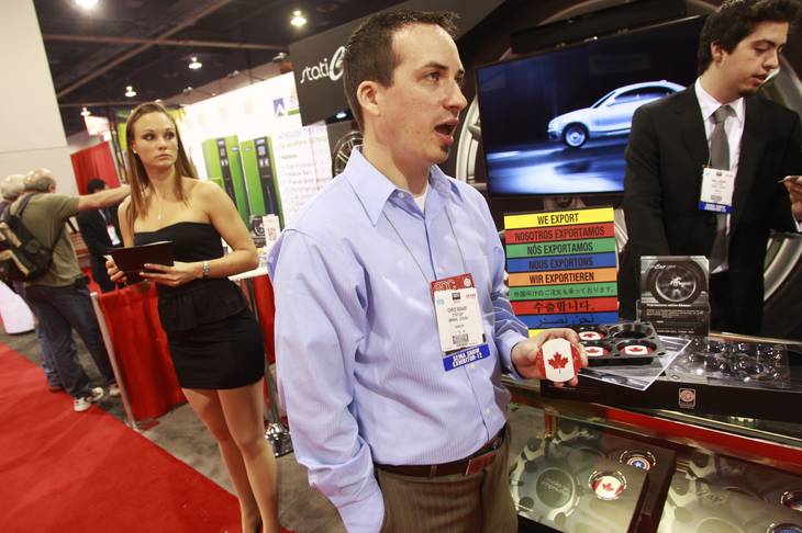 Chris Mahar from StaticCap displays the company's product at the SEMA show Tuesday, Oct. 30, 2012.