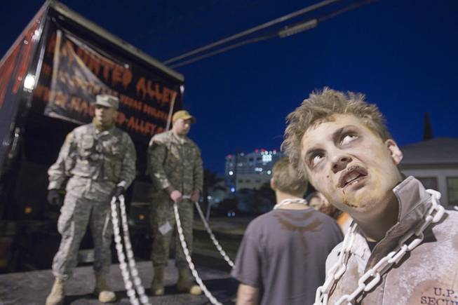 Zombie Josh Stackhouse, right, waits with a Silver State Productions Services entry during third annual Halloween Parade in downtown Las Vegas Wednesday, October 31, 2012.