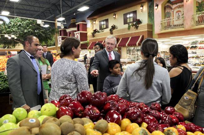 Sen. Harry Reid talks to shoppers in the produce section of the Cardenas Market on East Bonanza in Las Vegas after casting an early vote at the markets polling station on Wednesday, Oct. 31, 2012.
