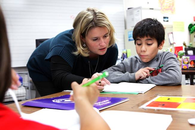 Manda Kristof, left, helps Andrew Rodriguez Quijano with an assignment while teaching a fifth grade writing class at Ferron Elementary School in Las Vegas on Wednesday, October 31, 2012.