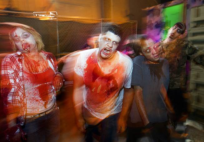 Best illustrated photo: Steve Marcus, of zombies going through a haunted alley during Halloween in downtown Las Vegas, on Wednesday, Oct. 31, 2012.