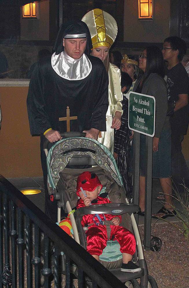 Vernon and Heidi Ferguson, dressed as a nun and the pope, push their little devil, Jean, 1, at the District's Halloween event at Green Valley Ranch in Henderson, Wednesday, Oct. 31, 2012.