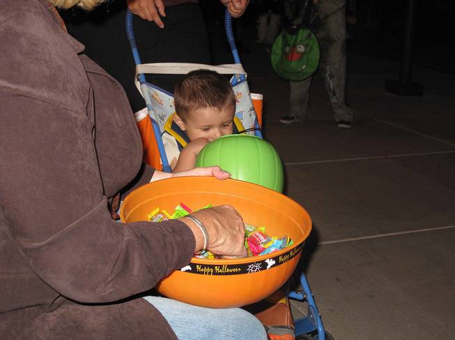 A young trick-or-treater checks out his Halloween loot at the District at Green Valley Ranch in Henderson, Wednesday, Oct. 31, 2012.