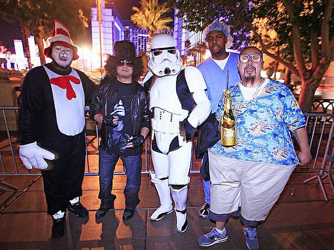 Seattle residents, from left, Chaeng Saeturn, Rodney Ofrancia, Jason Rosete, Joseph Lucas and Nai Saeteun celebrate Halloween on the Strip while in town for the SEMA convention, Oct. 31, 2012. 
