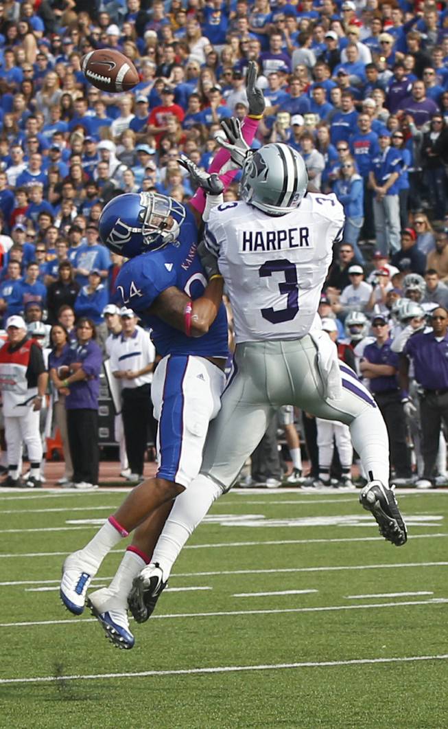 Kansas State wide receiver Chris Harper (3) goes up to catch a pass against Kansas safety Bradley McDougald (24) during the first half of an NCAA college football game in Lawrence, Kan., Saturday, Oct. 22, 2011.