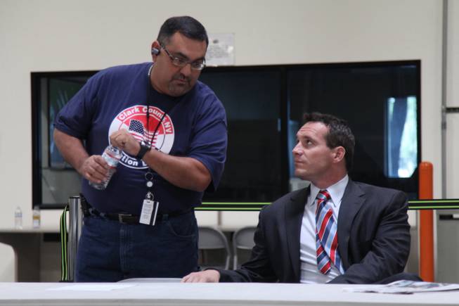 Nevada Secretary of State Ross Miller, right, talks to Joe Gloria, who directs programming and maintenance for Clark County’s elections division, before a news conference Saturday, Nov. 3, 2012.