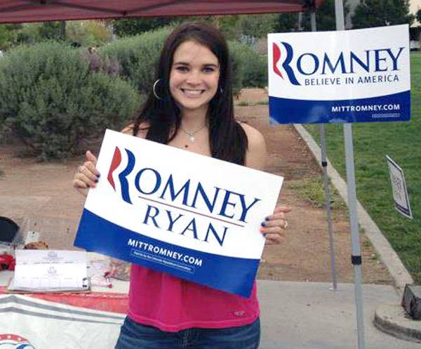 UNLV student Elizabeth Pelkowski, 21, poses with a Mitt Romney campaign sign while registering voters on campus. 