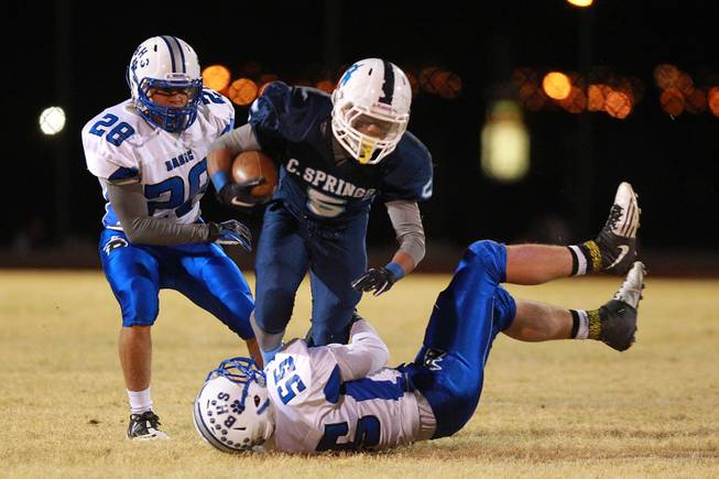 Canyon Springs Donnel Pumphrey is brought down by Basic Zachary Tritsch during their playoff game Friday, Nov. 9, 2012. Canyon Springs won 37-15.