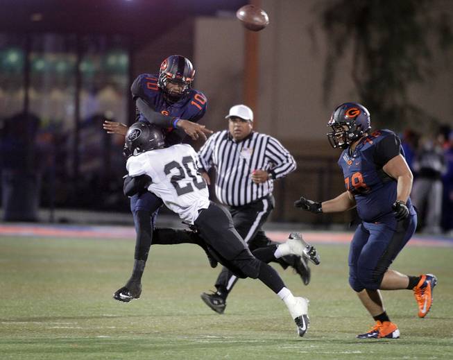 Randall Cunningham of Bishop Gorman makes a successful pass just before being tackled by Sean Dennis of Palo Verde during the Sunset Regional semifinals at Bishop Gorman High School in Las Vegas on Friday, November 9, 2012.