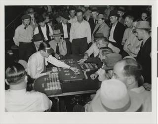 Photograph of men playing faro in a Fremont Street casino, circa 1930. 