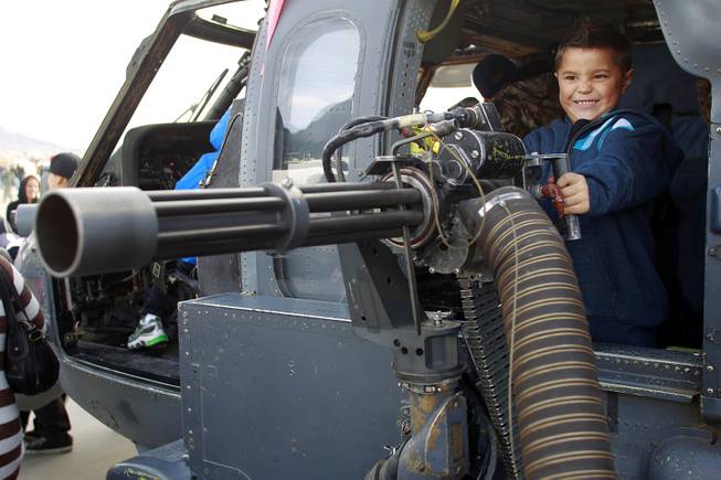 Six-year-old Kaimana Pepper plays with the machine gun on an ...