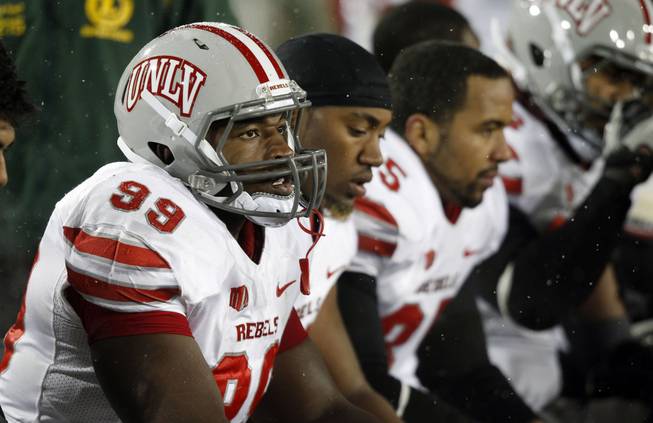 UNLV defensive lineman Tyler Gaston, front, joins teammates on the bench as time runs out in the fourth quarter of Colorado State's 33-11 victory over UNLV in an NCAA college football game in Fort Collins, Colo., Saturday, Nov. 10, 2012. (AP Photo/David Zalubowski)