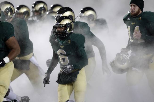 Surrounded by a cloud, Colorado State running back Chris Nwoke (6) joins teammates in taking the field against UNLV in the third quarter of Colorado State's 33-11 victory in an NCAA college football game in Fort Collins, Colo., Saturday, Nov. 10, 2012. (AP Photo/David Zalubowski)