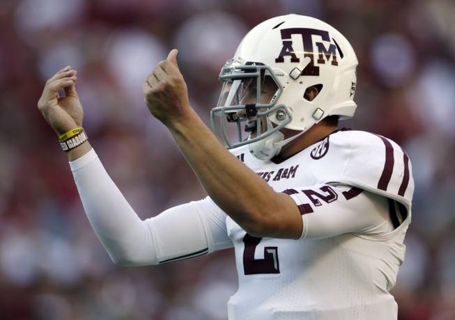 Texas A&M quarterback Johnny Manziel celebrates after the Aggies scored their third touchdown of the first quarter against Alabama at Bryant-Denny Stadium in Tuscaloosa, Ala., on Saturday, Nov. 10, 2012.