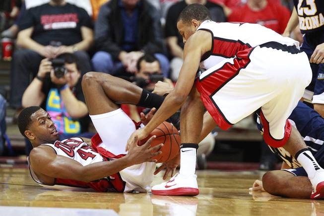 UNLV forward Mike Moser hands a loose ball off to Bryce Dejean Jones during the Rebels season opener against Northern Arizona Monday, Nov. 12, 2012 at the Thomas & Mack. UNLV won 92-54.