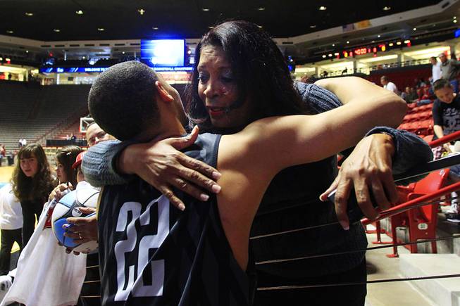 Justin Hawkins' mother, Carmen, hugs to Chace Stanback after practice before UNLV's second round NCAA Tournament game Wednesday, March 14, 2012 at The Pit in Albuquerque. Carmen, who is often at games despite living in Los Angeles, said she considers all of the Rebels players her sons by another mother.