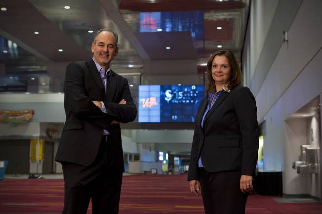 Mark Haley, President of Smart City Networks, and Jennifer Stefano, Manager of Digital Advertising, stand in front of the large digital wall in the Grand Concourse of the Las Vegas Convention Center, Tuesday Nov. 6, 2012.