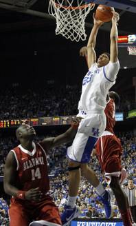 Kentucky's Anthony Davis, center, shoots between Alabama's Moussa Gueye (14) and JaMychal Green during the first half of an NCAA college basketball game in Lexington, Ky., Saturday, Jan. 21, 2012. Kentucky won 77-71. 