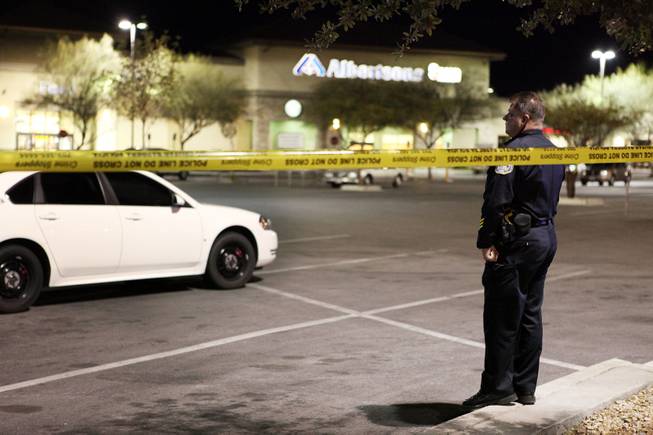 Henderson Police officers guard the scene outside of an Albertsons grocery store where Henderson Police shot a man Wednesday afternoon at the corner of Lake Mead Parkway and Boulder Highway in Henderson on Wednesday, November 14, 2012.