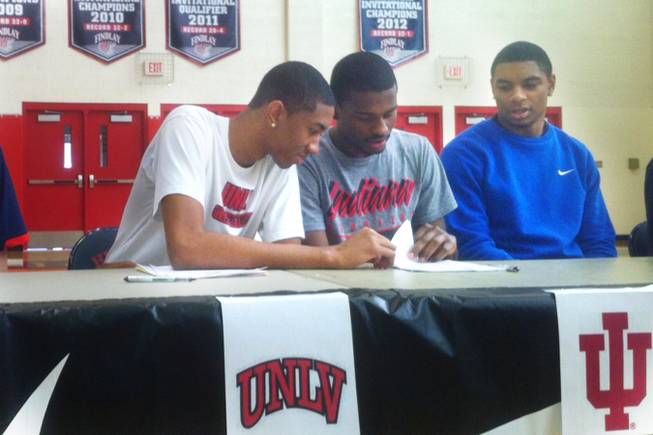 Findlay Prep and UNLV signee Christian Wood, left, reviews letter of intent paper work with teammate Stanford Robinson Wednesday, November, 14, 2012, at the Henderson International School. Wood signed with UNLV; Robinson inked with Indiana. Allerick Freeman (far right) is committed to UCLA and scheduled to sign Friday.