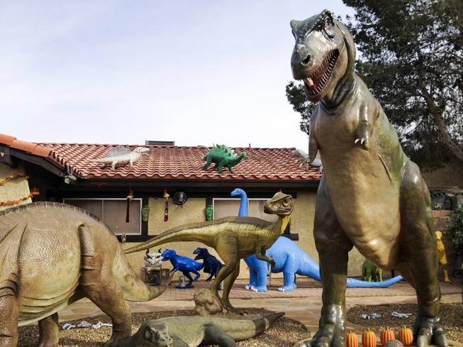 Steve Springers front yard is decked out with dinosaurs, Wednesday, Nov. 14, 2012.