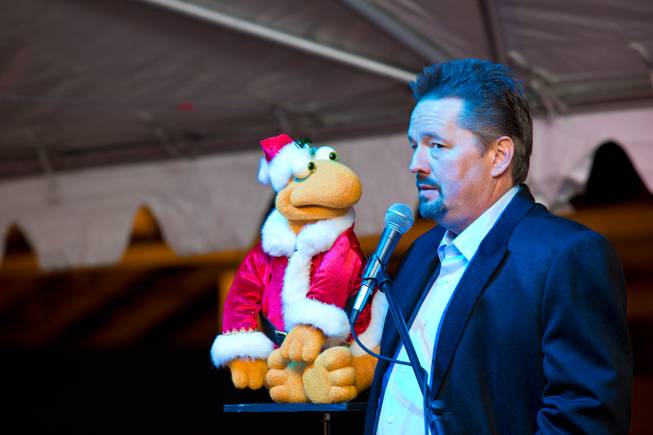 Terry Fator and Winston the Impersonating Turtle perform during the ceremonial opening of the Glittering Lights show at Las Vegas Motor Speedway on Thursday, Nov. 15, 2012.