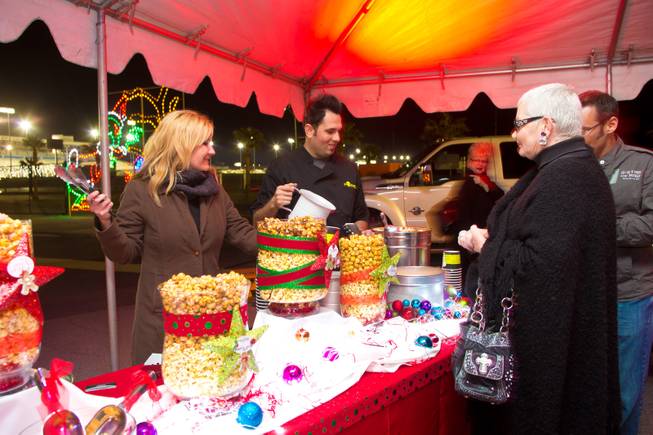 Zelma Watsubo and Oliver Morowati, of Popped, serve some of their gourmet popcorn during the ceremonial opening of the Glittering Lights show at Las Vegas Motor Speedway, Thursday, Nov. 15, 2012.