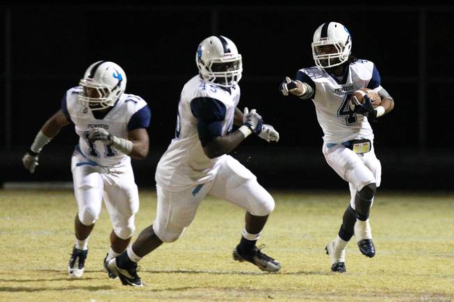 Canyon Springs Diamante Luna directs teammates Nigel Perry, left, and Kentabius Traylor on a kickoff return during their playoff game against Liberty Friday, Nov. 16, 2012. Liberty won 10-0.