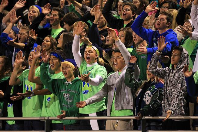 Green Valley students give a "Gater chomp" as they cheer on their team against Coronado during the Sunrise regional semifinal at Green Valley High School in Henderson Friday, November 16 , 2012.