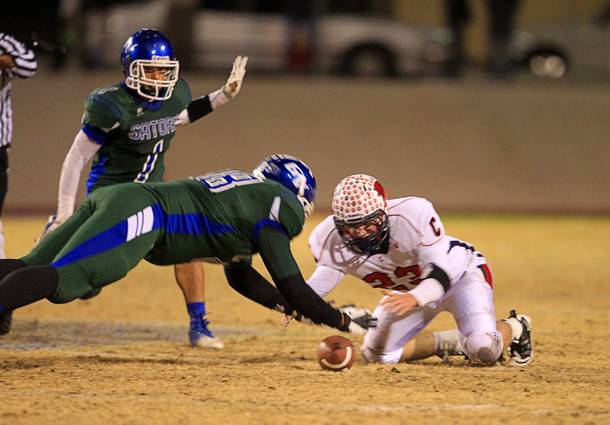 Green Valley's Tyrell Crosby recovers a Green Valley fumble in front of Coronado's Marcus Hunt during the Sunrise regional semifinal at Green Valley High School in Henderson Friday, November 16 , 2012.
