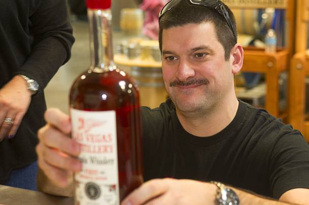 Mat Young of Park City, Utah applies a label to a bottle of Nevada whiskey during the Historic First Edition Day at the Las Vegas Distillery in Henderson Saturday, November 17, 2012. The event marks the first bottling of several new spirits and the grand opening of the Booze Brothers Beverage distribution company and the Half Full Artisan Shop at the Distillery, a retail store. The spirits include Nevada vodka, whiskey, gin, rum and moonshine.