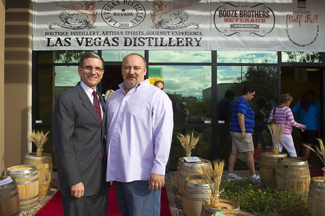 Congressman Joe Heck (R-NV), left, poses with Las Vegas Distillery founder George Racz during the Historic First Edition Day at the Las Vegas Distillery in Henderson Saturday, November 17, 2012. The event marks the first bottling of several new spirits and the grand opening of the Booze Brothers Beverages distribution company and the Half Full Artisan Shop at the Distillery, a retail store. The spirits include Nevada vodka, whiskey, gin, rum and moonshine.