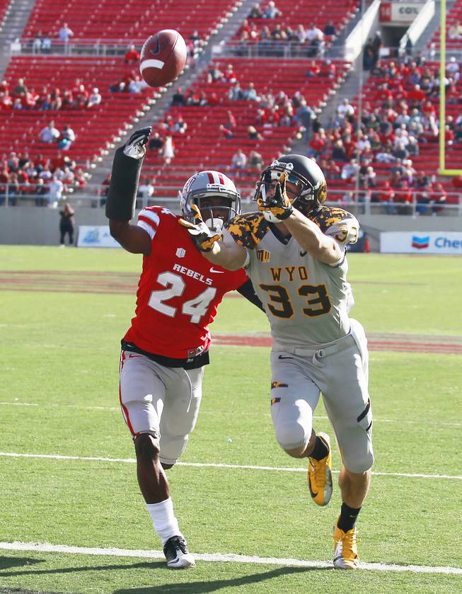 UNLV defensive back Fred Wilson defends Wyoming wide receiver Dominic Rufran during the first half of their game Saturday, Nov. 17, 2012 at Sam Boyd Stadium.