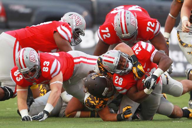 UNLV running back Bradley Randle is brought down by a Wyoming player during their game Saturday, Nov. 17, 2012 at Sam Boyd Stadium. Wyoming won 28-23.