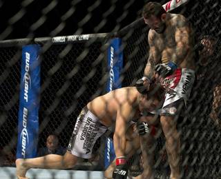 Patrick Cote, left, from Canada, is knocked down by Alessio Sakara during their UFC 154 middleweight bout on Saturday, Nov. 17, 2012, in Montreal. Cote won the bout after Sakara was disqualified. (AP Photo/The Canadian Press, Ryan Remiorz)